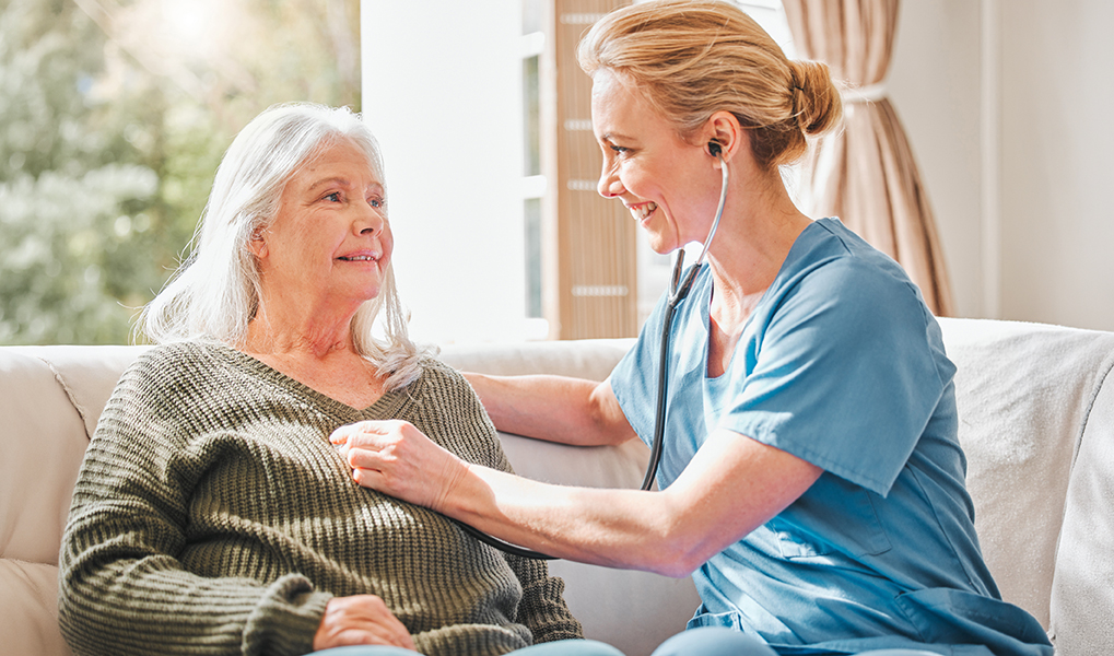 Woman, senior and nurse with stethoscope for listening, healthca